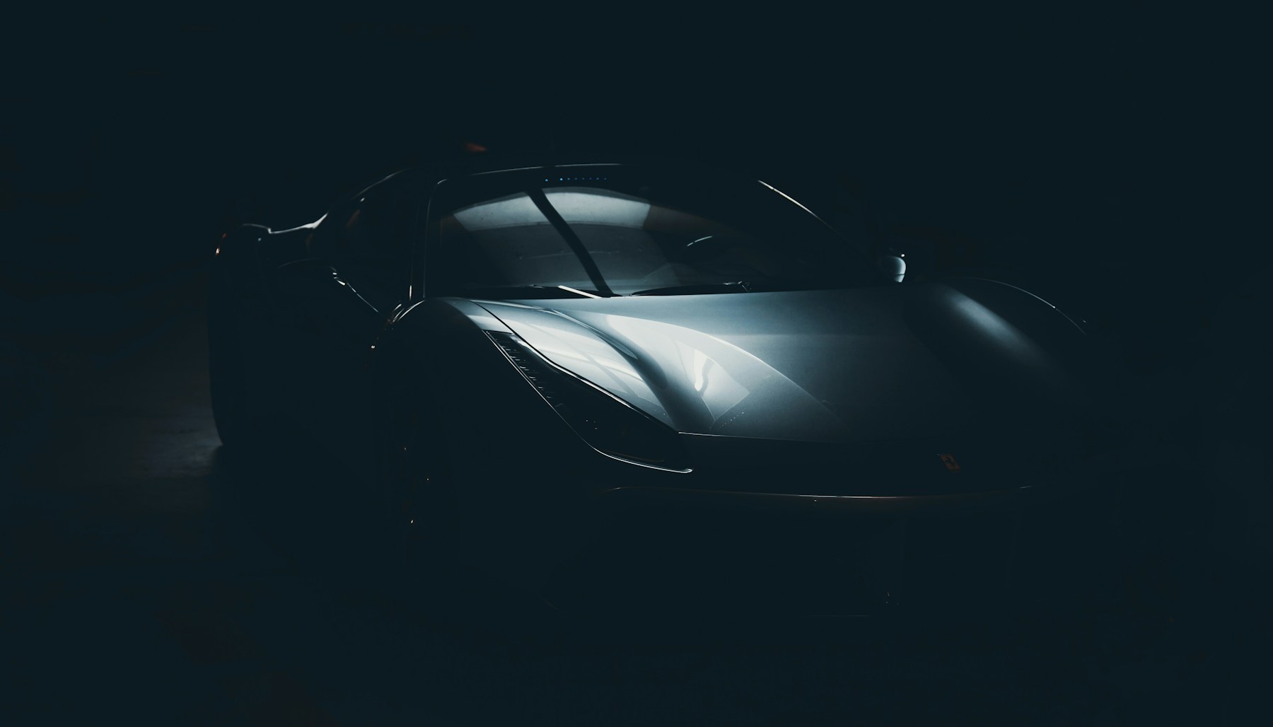 Black classic sports car in a dark studio